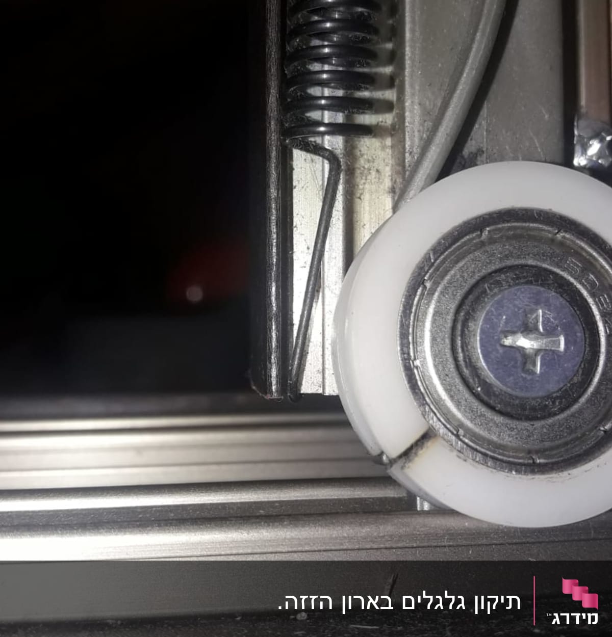 גלגלת מתכת עם קפיץ על מסילה